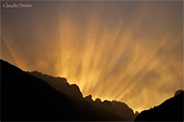 crinale della montagna all'alba con splendidi raggi di luce tra le nuvole